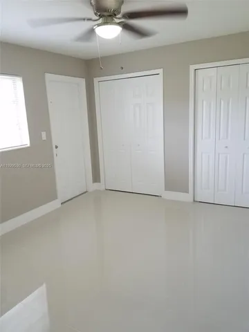 an empty room with a ceiling fan