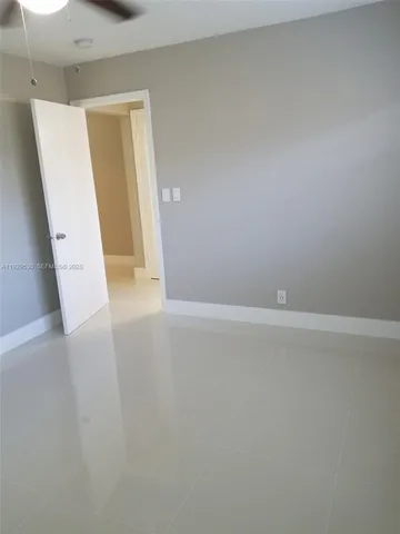 a view of room with window and wooden floor