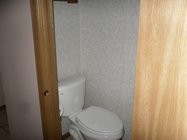 9 North Oltendorf Road Streamwood, IL 60107 - Photo 7 of 14 a white toilet sitting next to a shower curtain