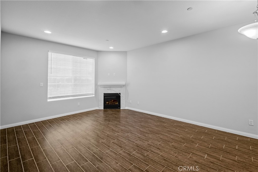 4617 Alekona Ct. Cypress, CA 90630 - Photo 13 of 35 a view of an empty room with wooden floor and a window