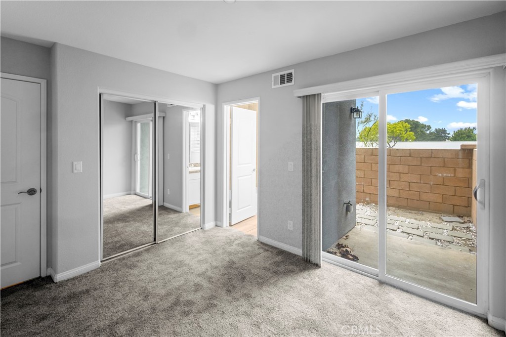 4617 Alekona Ct. Cypress, CA 90630 - Photo 5 of 35 an empty room with sliding glass door and mountain view