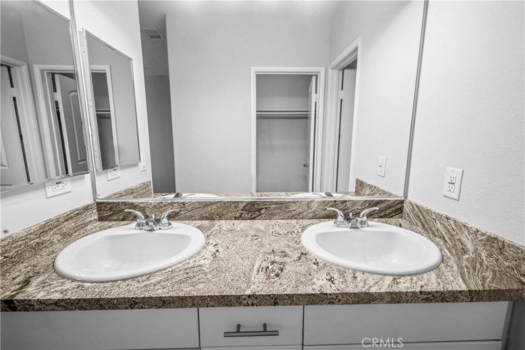 4617 Alekona Ct. Cypress, CA 90630 - Photo 8 of 35 a bathroom with sinks granite granite and a sink