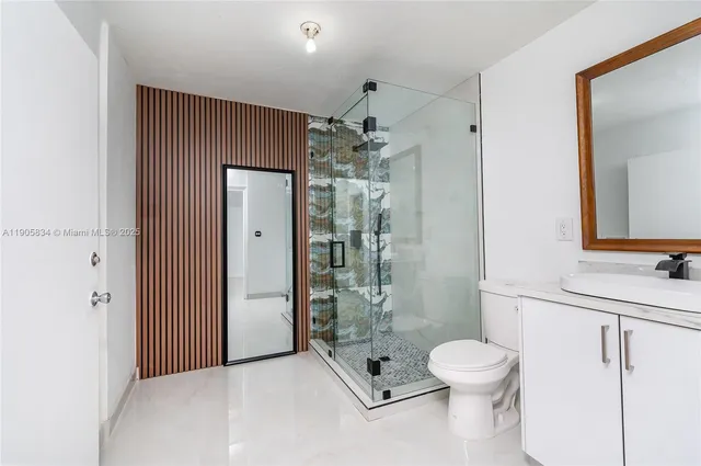 a bathroom with a shower a sink and mirror