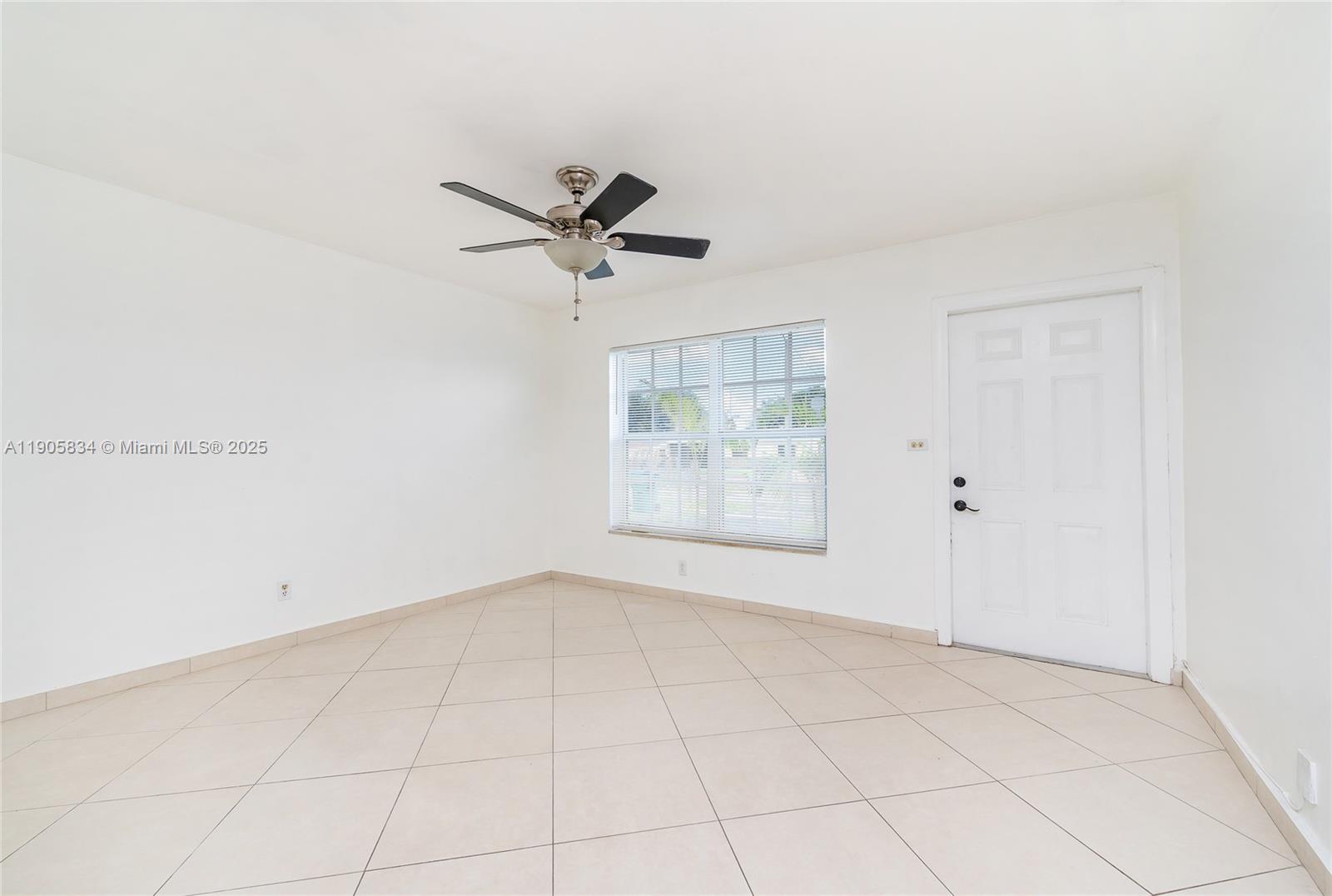 5420 Northwest 182nd Street Miami Gardens, FL 33055 - Photo 27 of 35 an empty room with white walls and ceiling fan