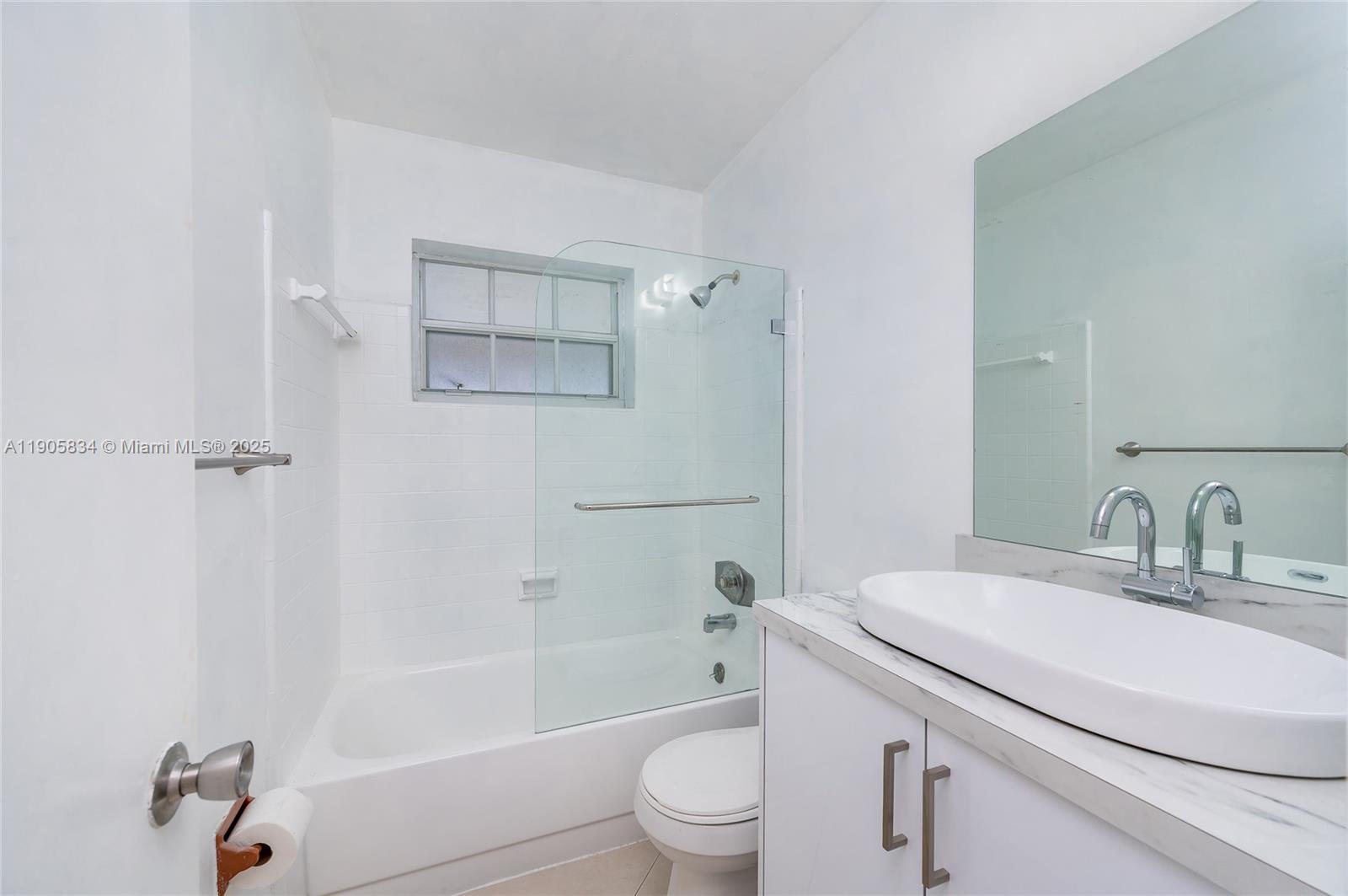 5420 Northwest 182nd Street Miami Gardens, FL 33055 - Photo 31 of 35 a bathroom with a sink toilet and shower