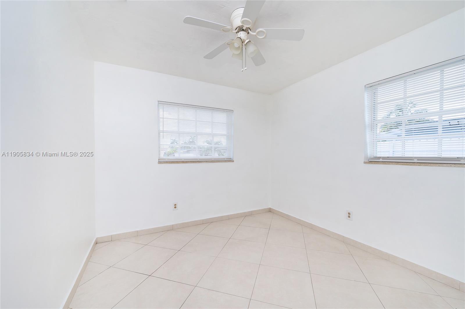 5420 Northwest 182nd Street Miami Gardens, FL 33055 - Photo 32 of 35 an empty room with a window and a fan