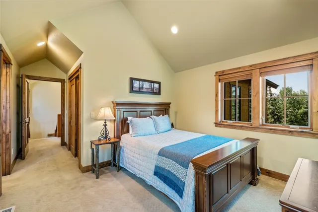 a bedroom with a bed and a large window