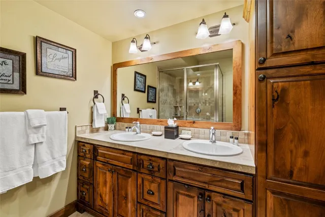 a bathroom with a sink double vanity and a mirror