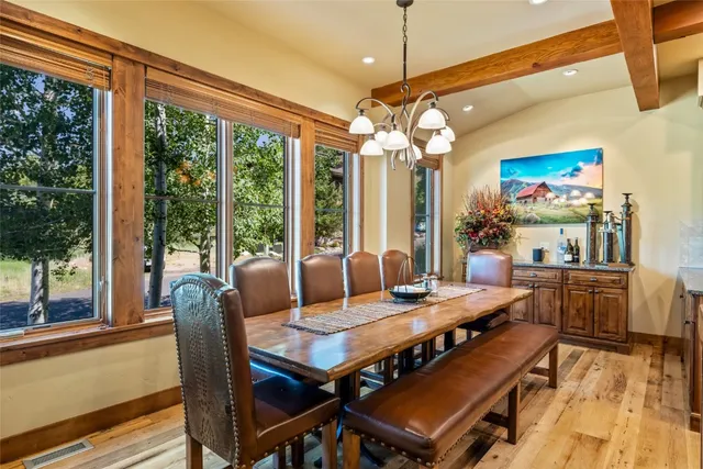 a view of a dining room with furniture large windows and wooden floor