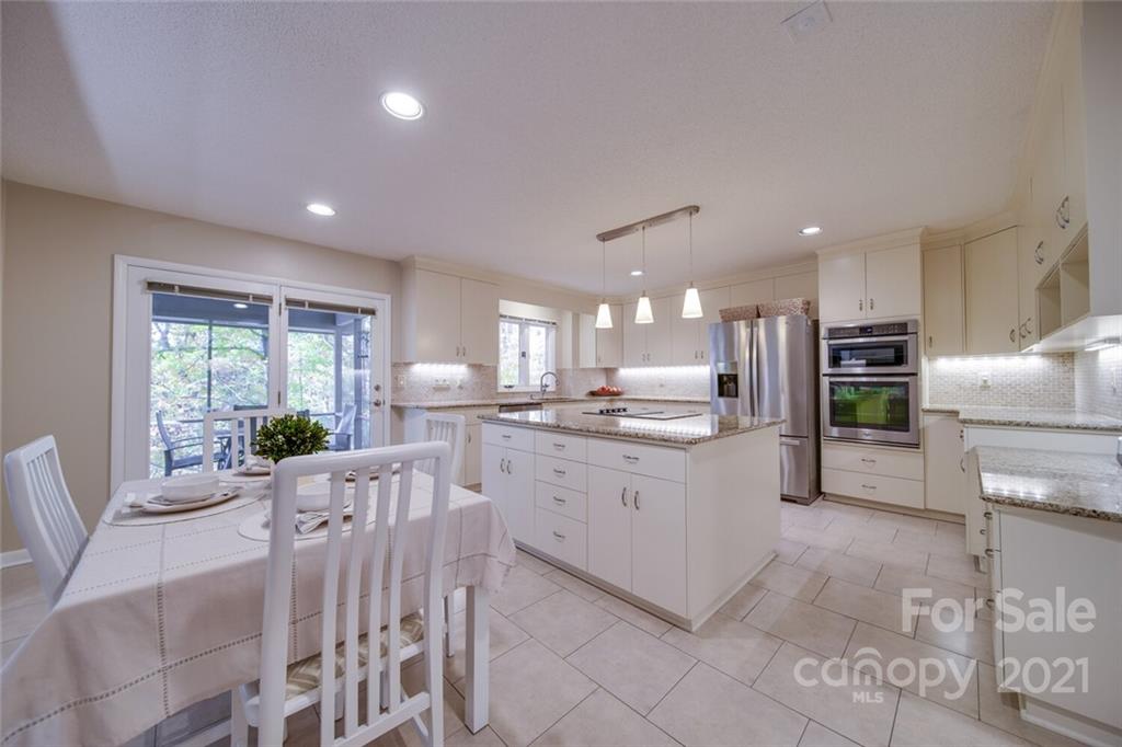 105 Den Road Wadesboro, NC 28170 - Photo 14 of 47 a large white kitchen with lots of counter space dining table and stainless steel appliances