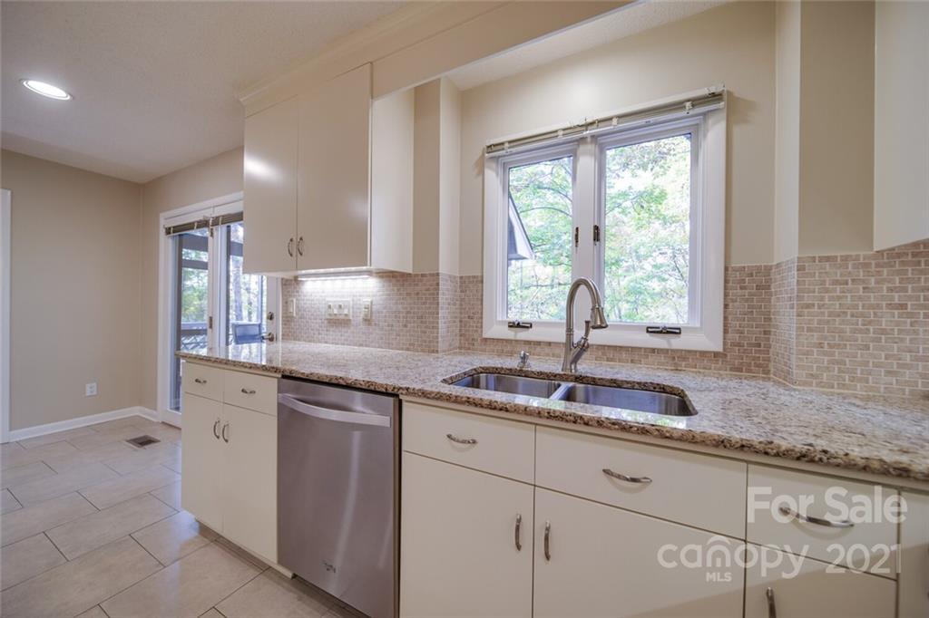 105 Den Road Wadesboro, NC 28170 - Photo 18 of 47 a kitchen with granite countertop a sink and a window