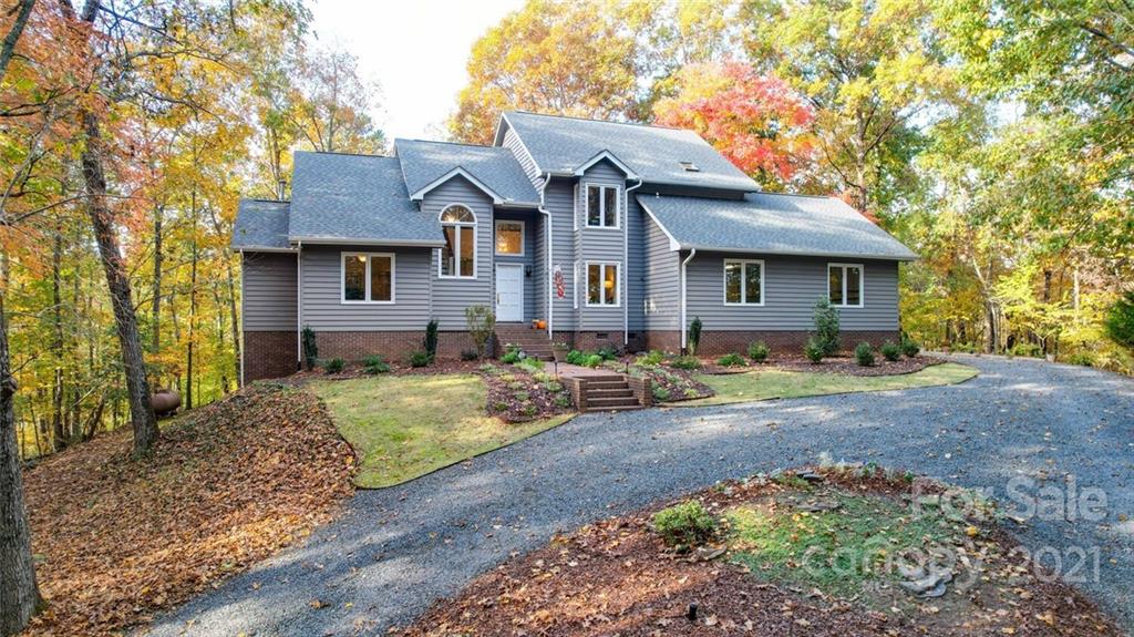 105 Den Road Wadesboro, NC 28170 - Photo 3 of 47 a front view of a house with a yard and large tree