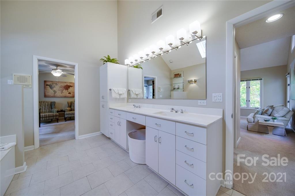 105 Den Road Wadesboro, NC 28170 - Photo 33 of 47 a spacious bathroom with a granite countertop sink a large mirror and a shower