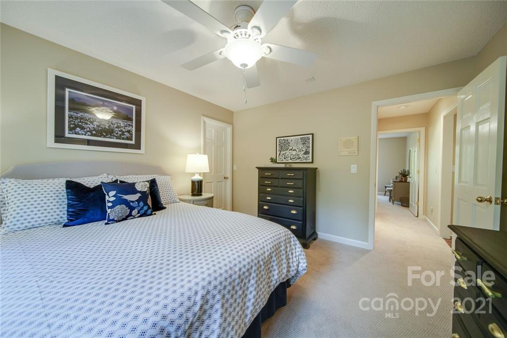 105 Den Road Wadesboro, NC 28170 - Photo 45 of 47 a bedroom with a bed and a chandelier