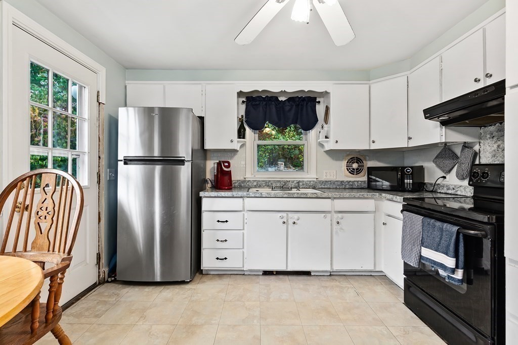 195 Den Quarry Road Lynn, MA 01904 - Photo 13 of 28 a kitchen with stainless steel appliances granite countertop a refrigerator sink and stove