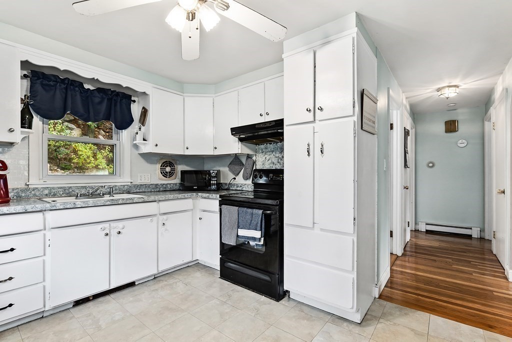 195 Den Quarry Road Lynn, MA 01904 - Photo 14 of 28 a kitchen with granite countertop white cabinets and white appliances