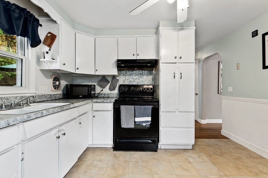 195 Den Quarry Road Lynn, MA 01904 - Photo 15 of 28 a kitchen with white cabinets and appliances