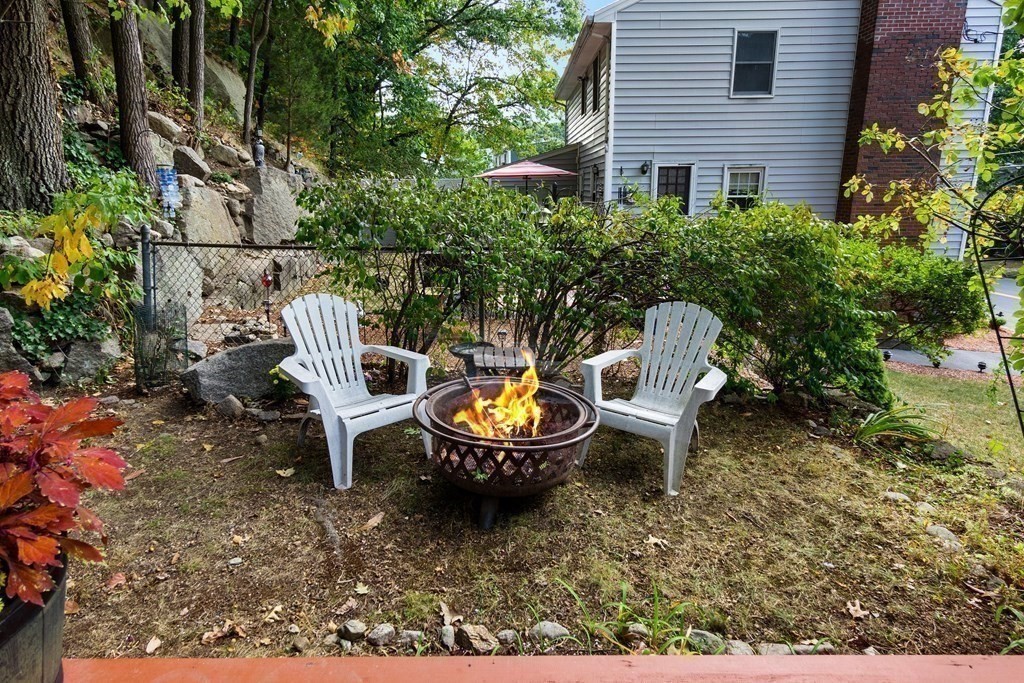 195 Den Quarry Road Lynn, MA 01904 - Photo 26 of 28 a view of a patio with table and chairs potted plants and large tree