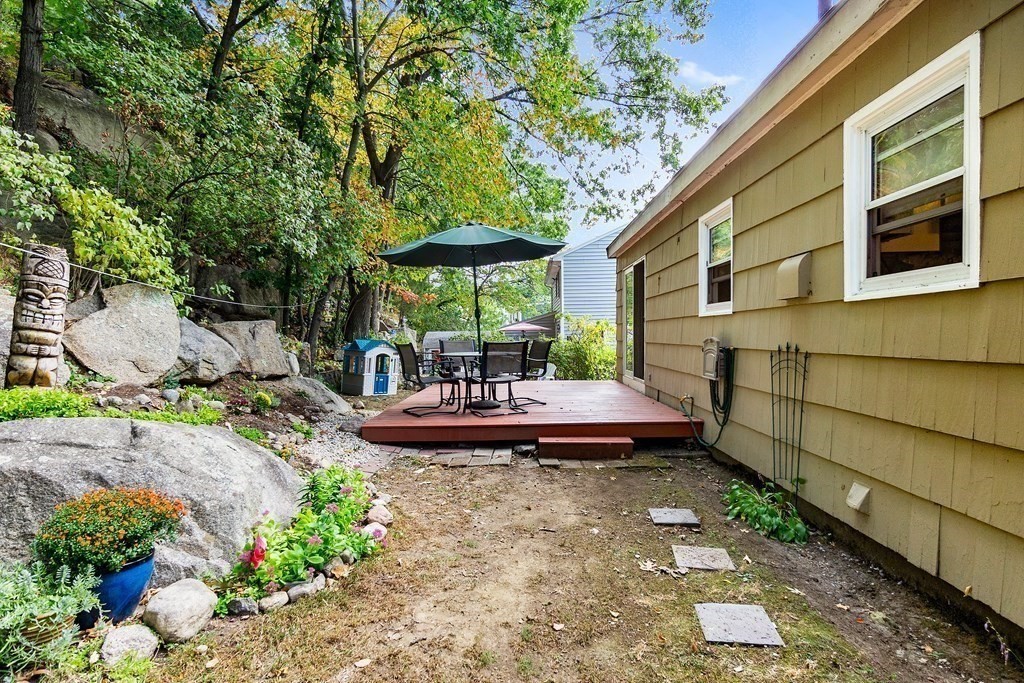 195 Den Quarry Road Lynn, MA 01904 - Photo 27 of 28 a view of a backyard with table and chairs under an umbrella