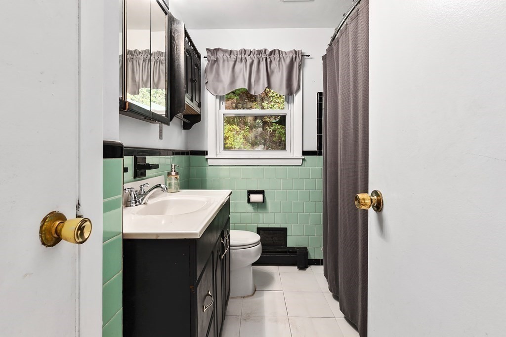 195 Den Quarry Road Lynn, MA 01904 - Photo 10 of 28 a bathroom with a sink toilet and mirror