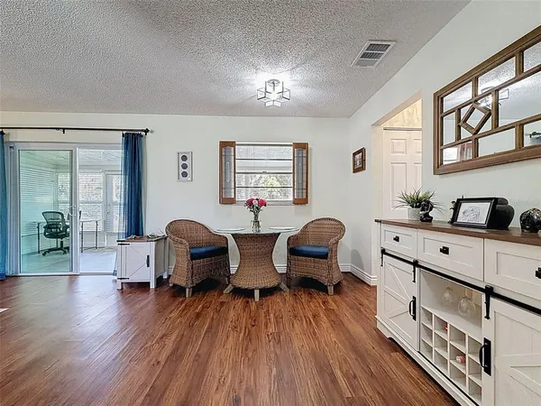 a view of a dining room with furniture window and wooden floor