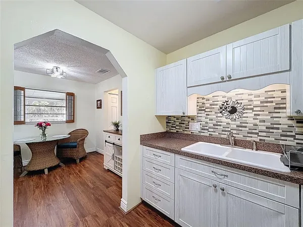 a kitchen with granite countertop a sink stainless steel appliances and cabinets