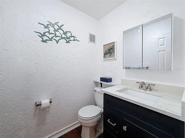a bathroom with a sink toilet and mirror