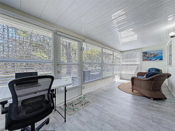 a work room with furniture and a large window
