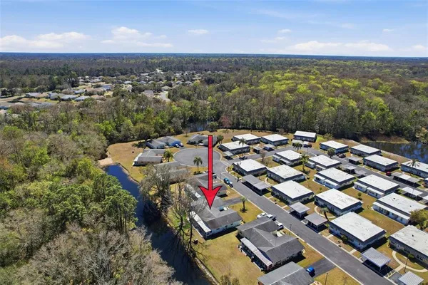 an aerial view of a houses with a city view