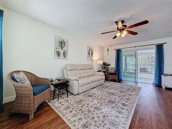 a living room with furniture and wooden floor