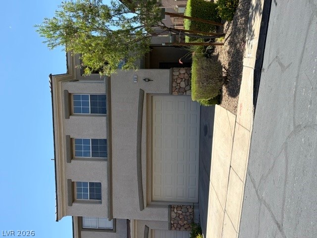 A traditional multi-story residence with an attached garage and well-maintained landscaping.