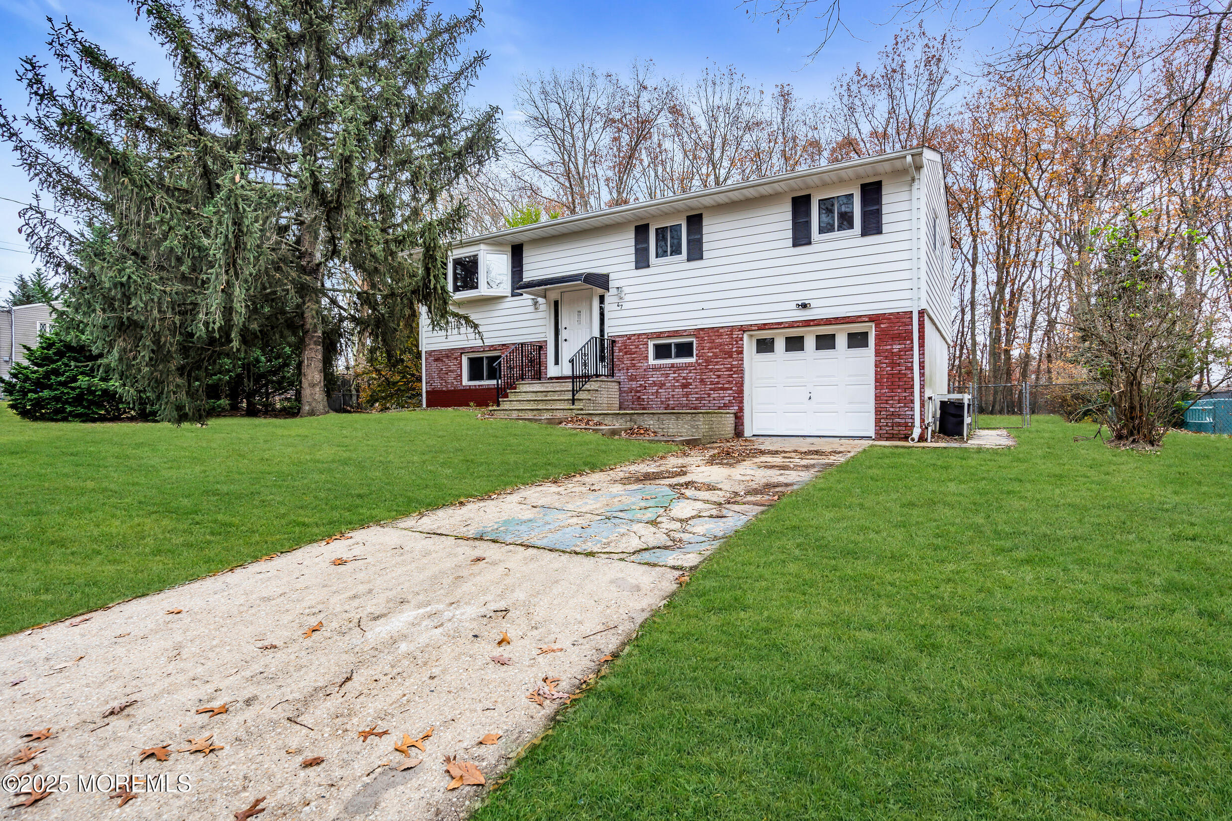 47 Beam Avenue Jackson, NJ 08527 - Photo 11 of 22 a front view of a house with a garden and trees