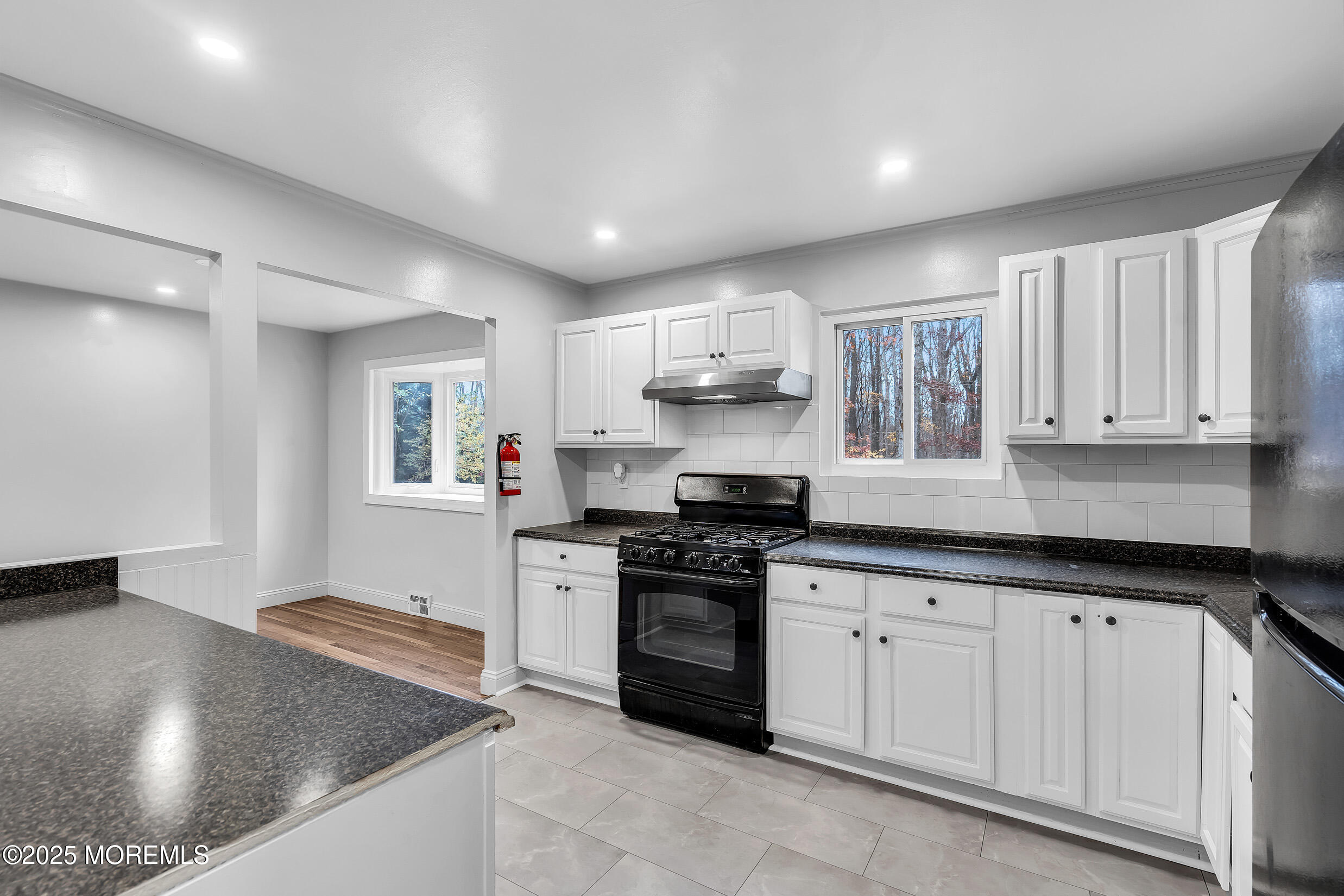 47 Beam Avenue Jackson, NJ 08527 - Photo 19 of 22 a kitchen with stainless steel appliances granite countertop a sink stove and cabinets