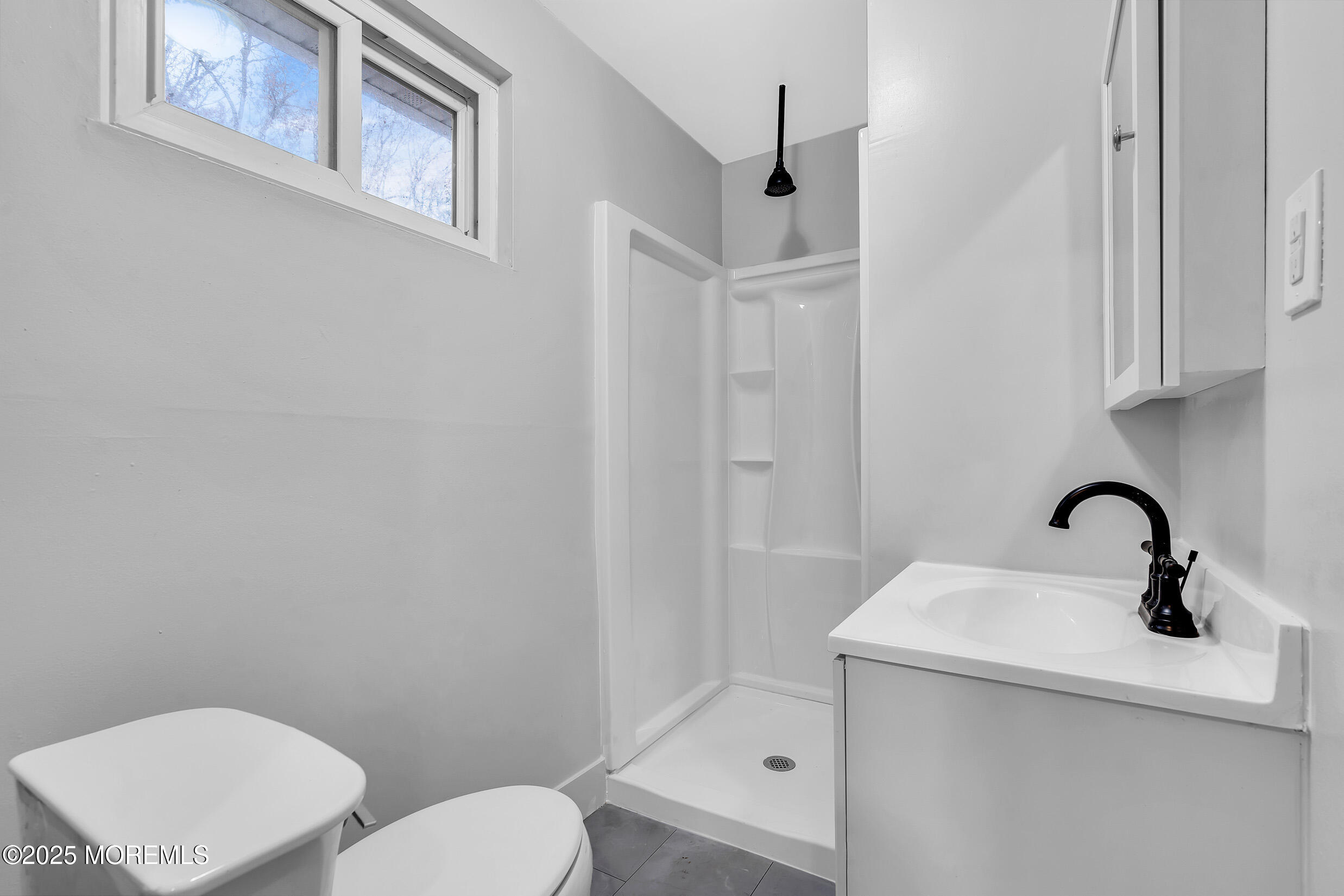 47 Beam Avenue Jackson, NJ 08527 - Photo 4 of 22 a bathroom with a toilet a sink and mirror
