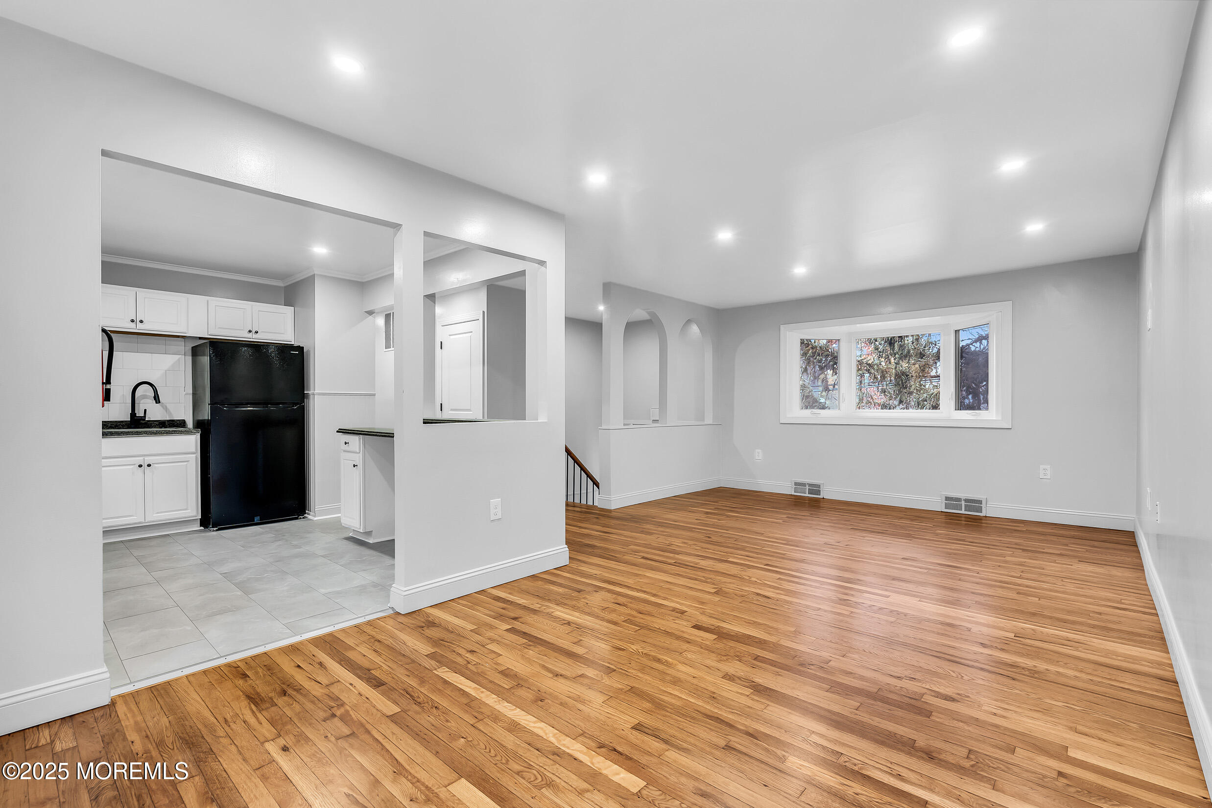 47 Beam Avenue Jackson, NJ 08527 - Photo 6 of 22 a view of an empty room with wooden floor and a kitchen
