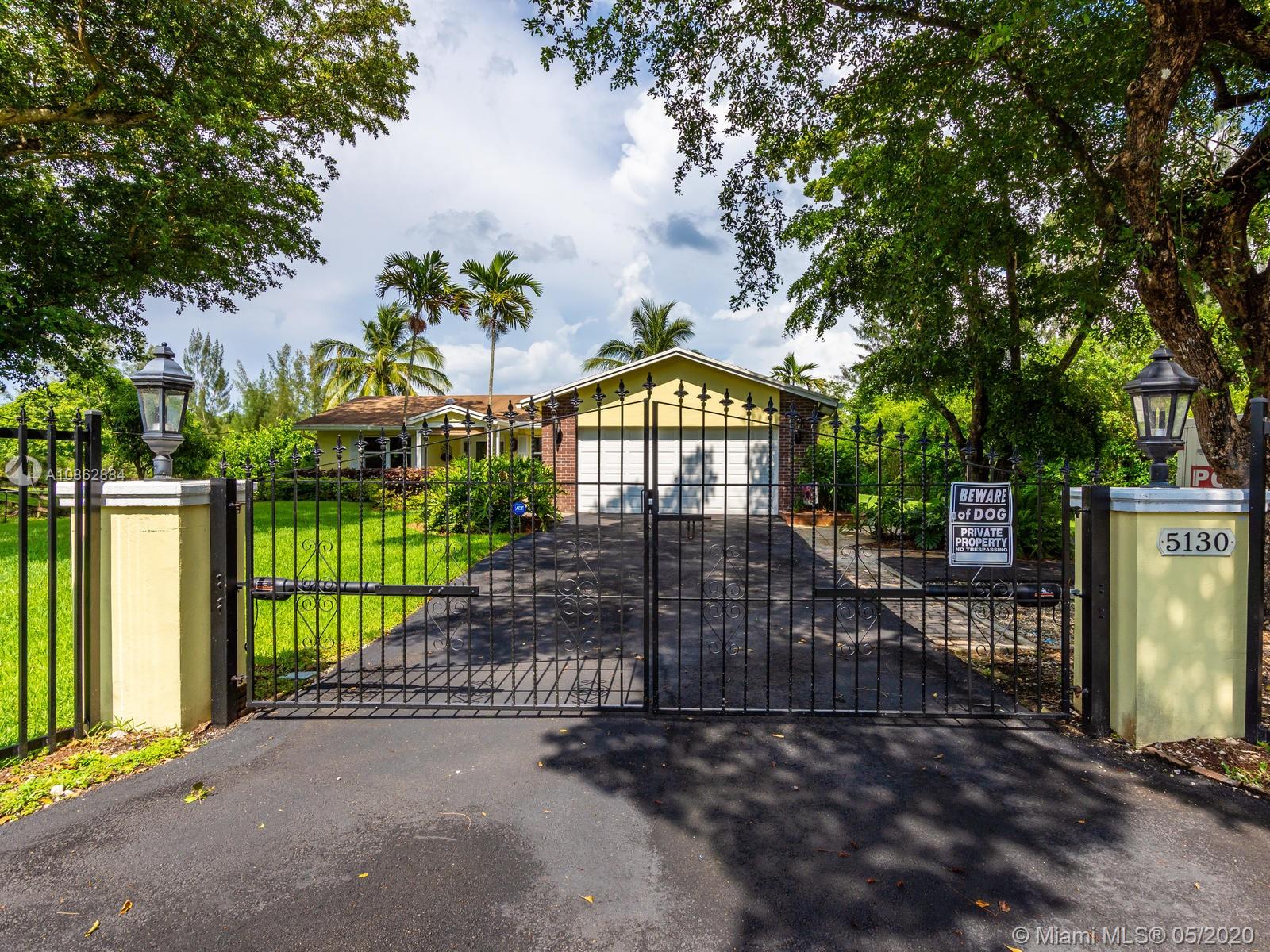 5130 Southwest 170th Avenue Southwest Ranches, FL 33331 - Photo 1 of 83 ENTER THROUGH ELECTRONIC WROUGHT IRON DOUBLE GATES TO ACCESS THE HOME.