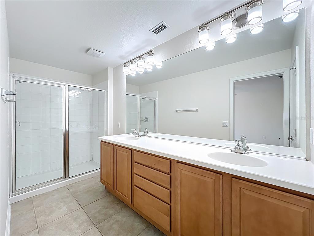 12930 Vennetta Way Windermere, FL 34786 - Photo 20 of 38 a bathroom with a sink double vanity and a mirror