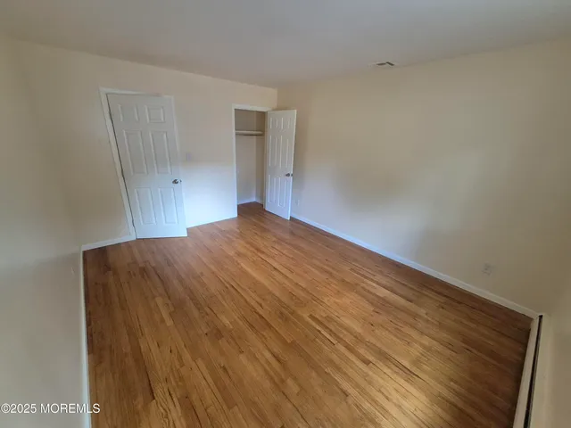 a bedroom with a bed and a night stand