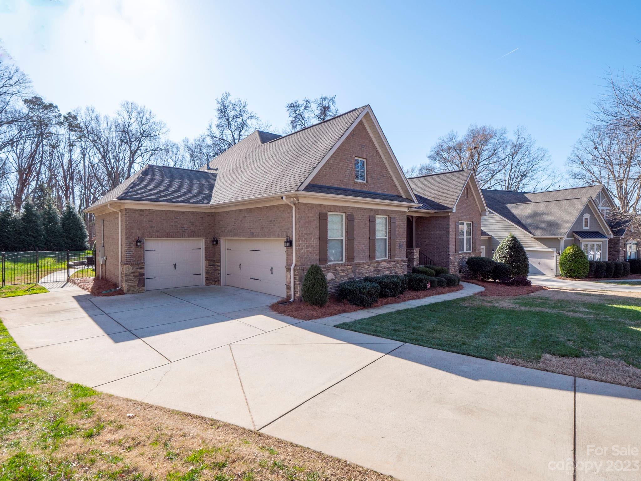 4226 Morris Park Drive, Unit 2 Mint Hill, NC 28227 - Photo 2 of 48 a view of a white house next to a yard with big trees