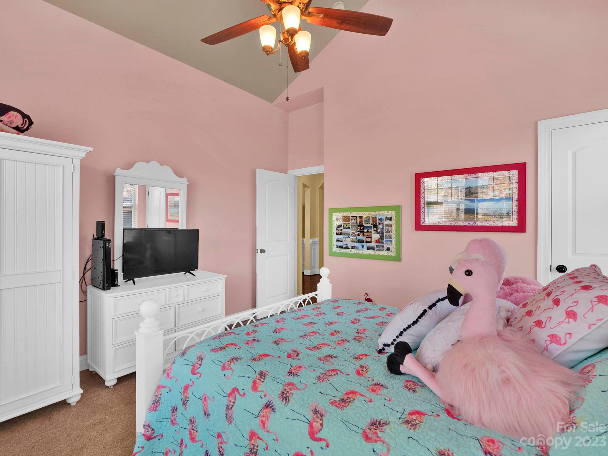 4226 Morris Park Drive, Unit 2 Mint Hill, NC 28227 - Photo 21 of 48 a bedroom with a bed and a chandelier