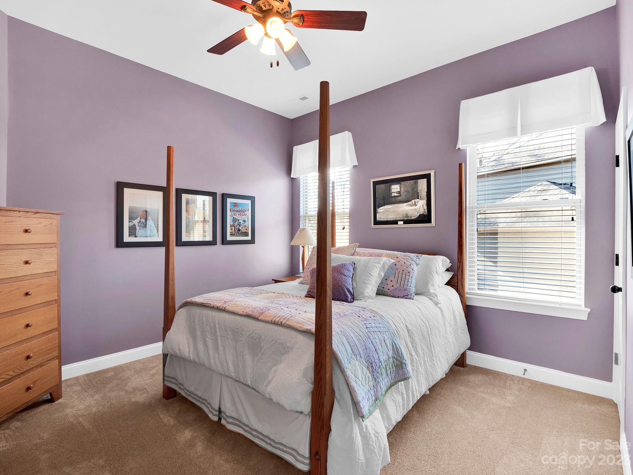 4226 Morris Park Drive, Unit 2 Mint Hill, NC 28227 - Photo 22 of 48 a bedroom with a bed chandelier and a window