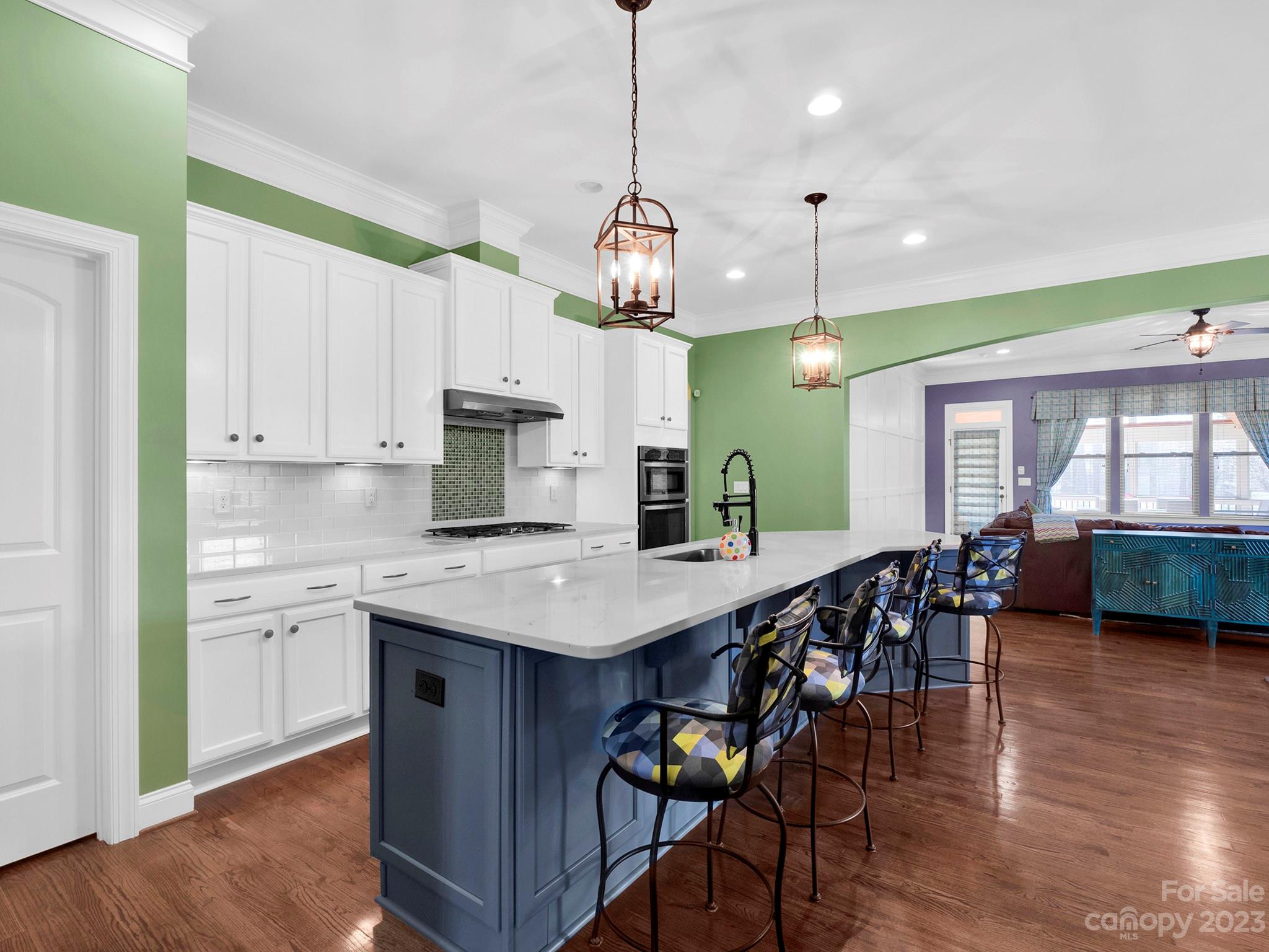 4226 Morris Park Drive, Unit 2 Mint Hill, NC 28227 - Photo 25 of 48 a kitchen with stainless steel appliances granite countertop a kitchen island a stove a table and chairs in it