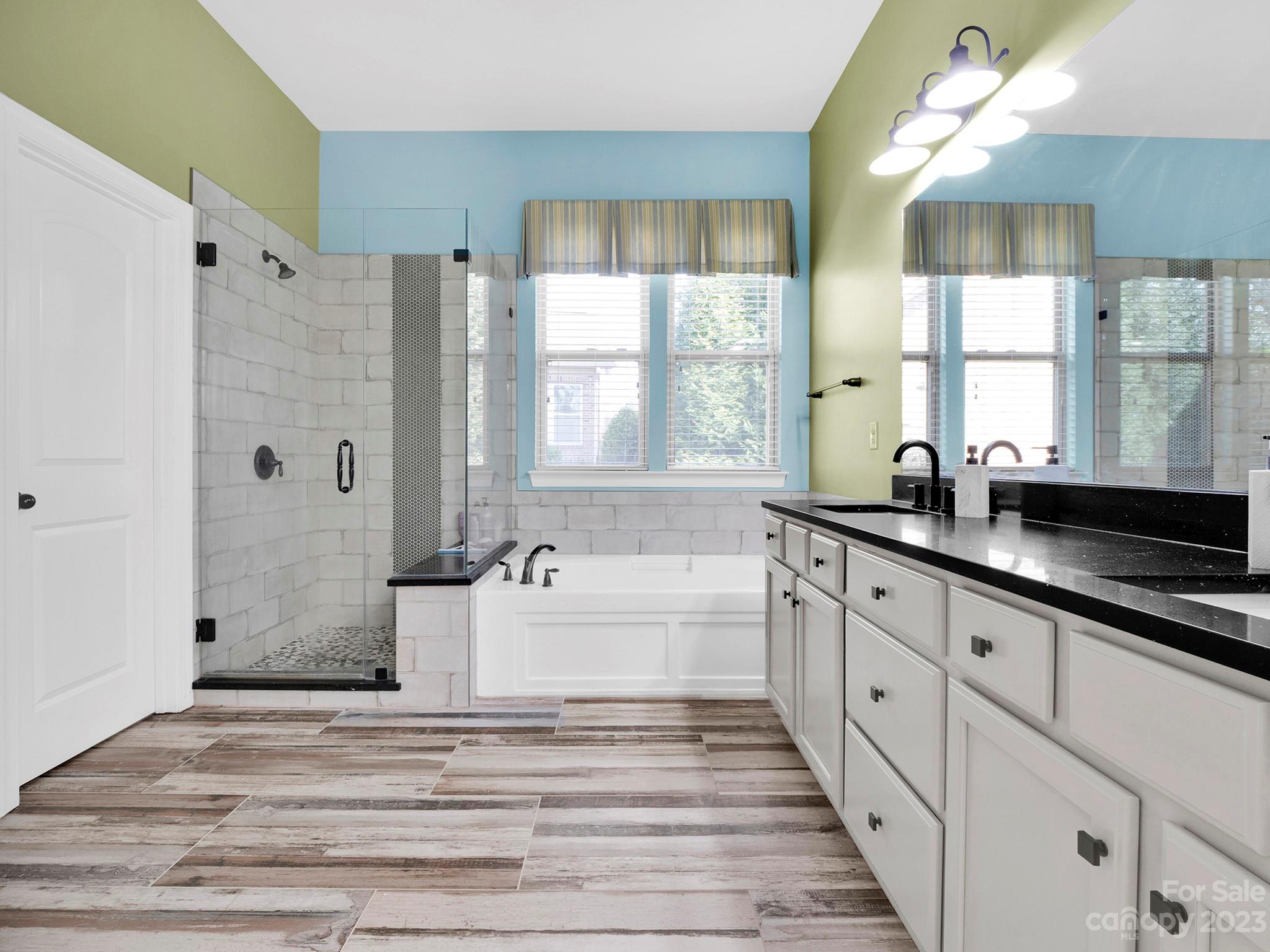 4226 Morris Park Drive, Unit 2 Mint Hill, NC 28227 - Photo 38 of 48 a spacious bathroom with sinks mirror and a bathtub
