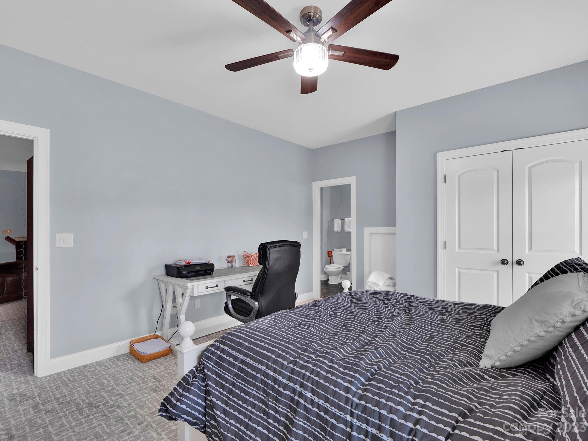 4226 Morris Park Drive, Unit 2 Mint Hill, NC 28227 - Photo 47 of 48 a bedroom with a bed and a chandelier