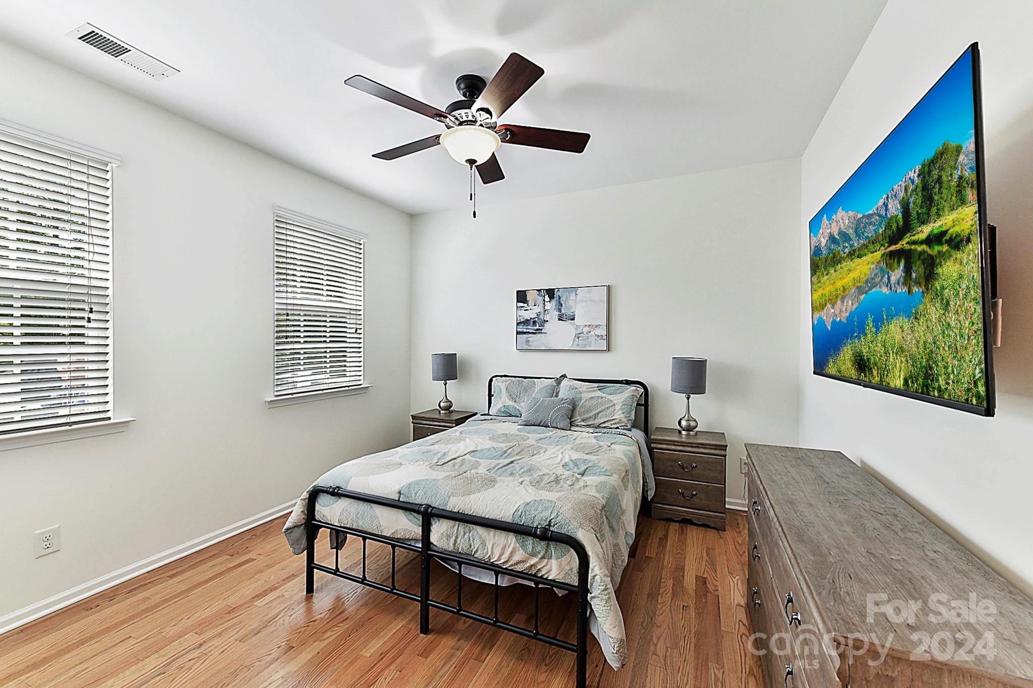 1201 Screech Owl Road Waxhaw, NC 28173 - Photo 17 of 43 a bedroom with a bed and a painting on the wall