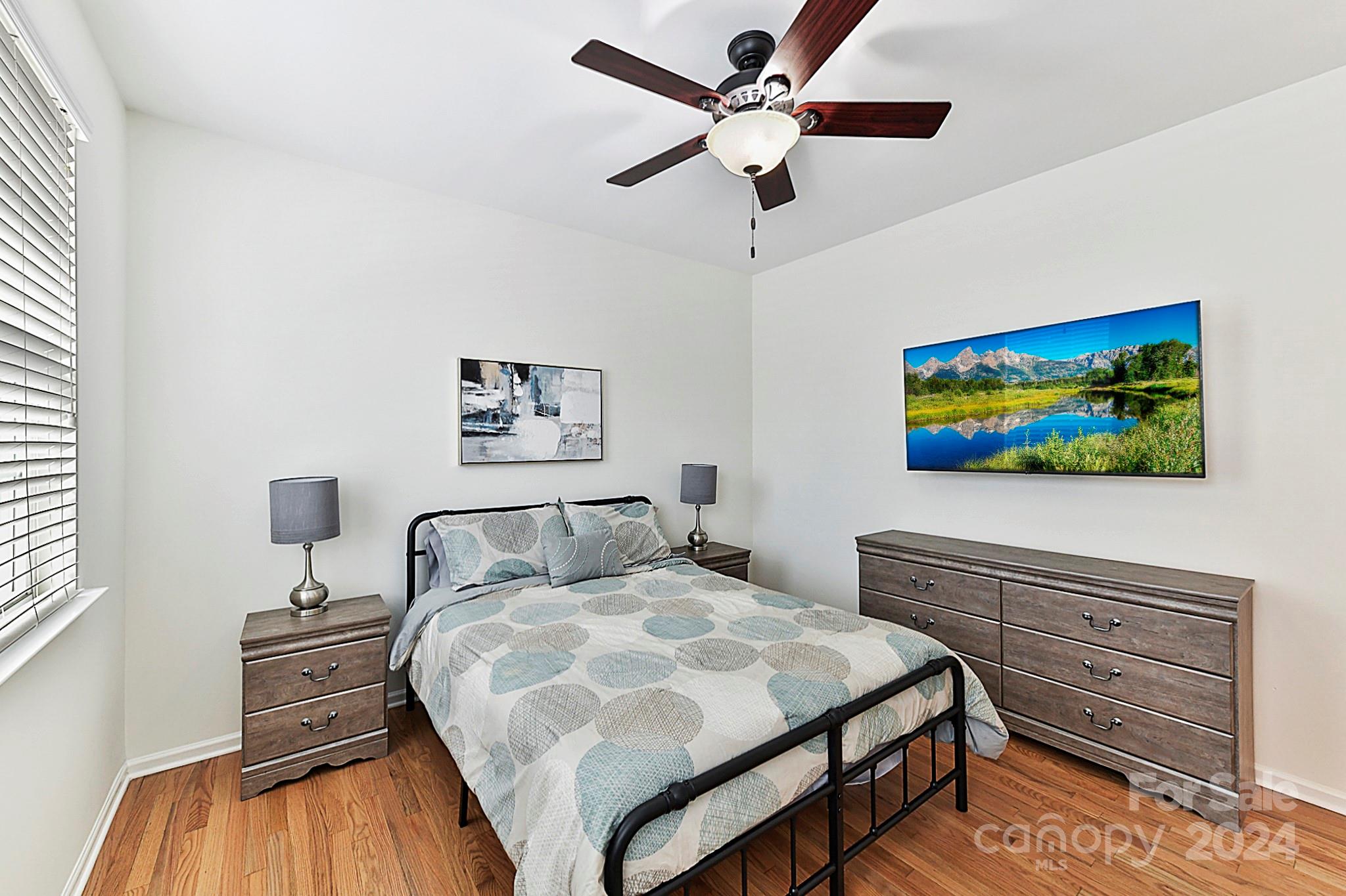 1201 Screech Owl Road Waxhaw, NC 28173 - Photo 18 of 43 a bedroom with a bed and a flat screen tv