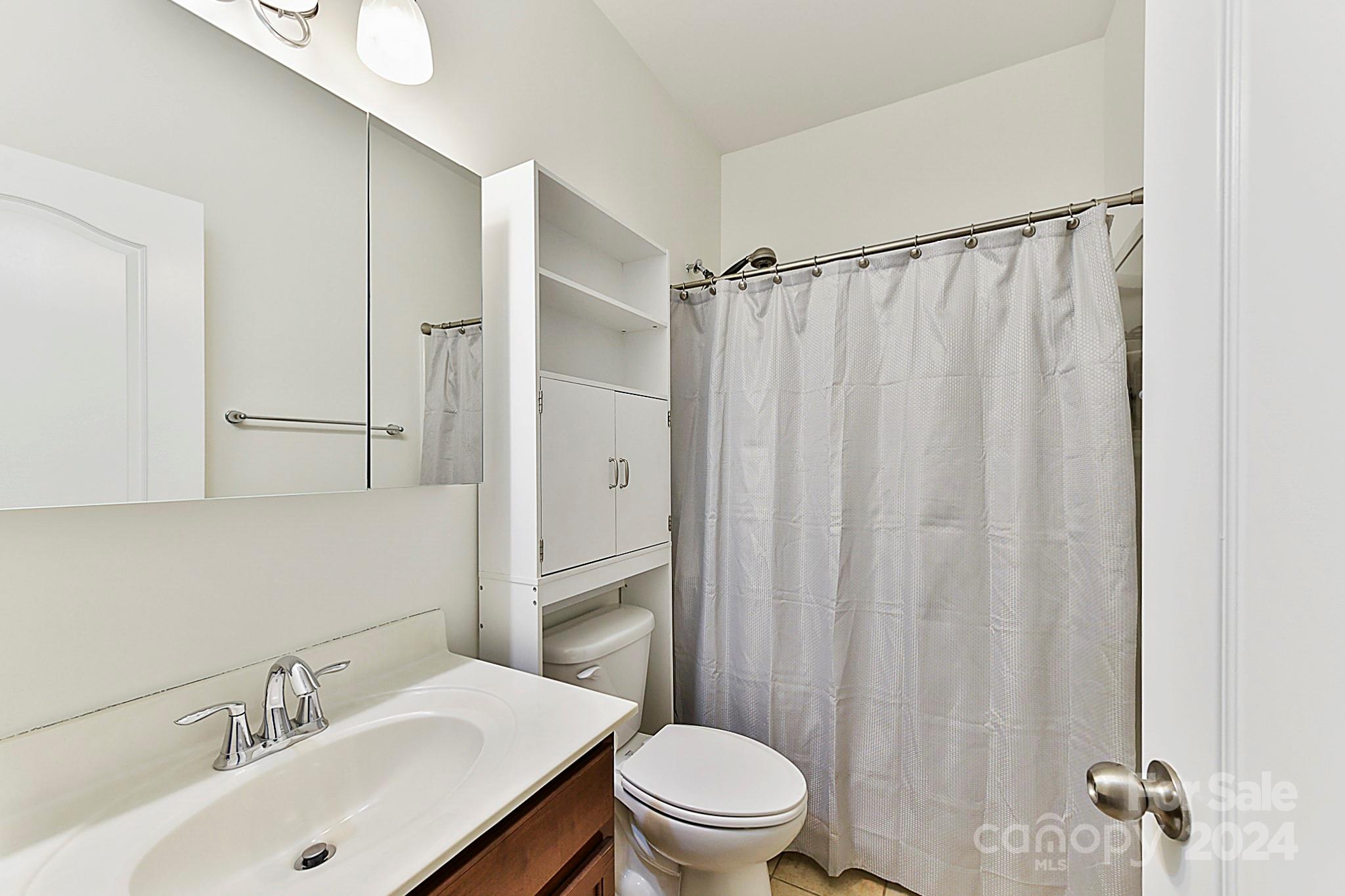 1201 Screech Owl Road Waxhaw, NC 28173 - Photo 19 of 43 a bathroom with a sink toilet and shower