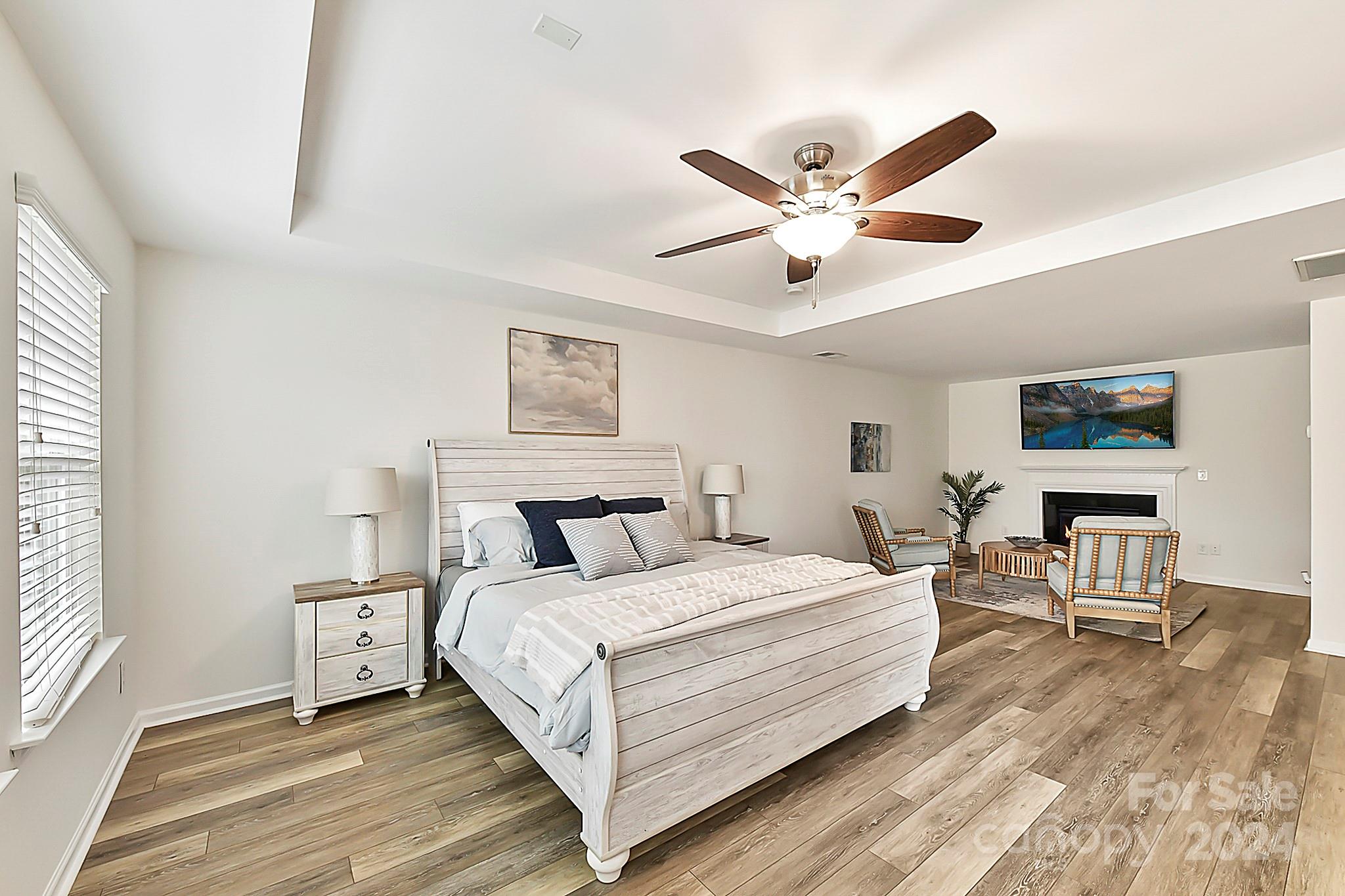 1201 Screech Owl Road Waxhaw, NC 28173 - Photo 24 of 43 a bedroom with a bed and a chandelier