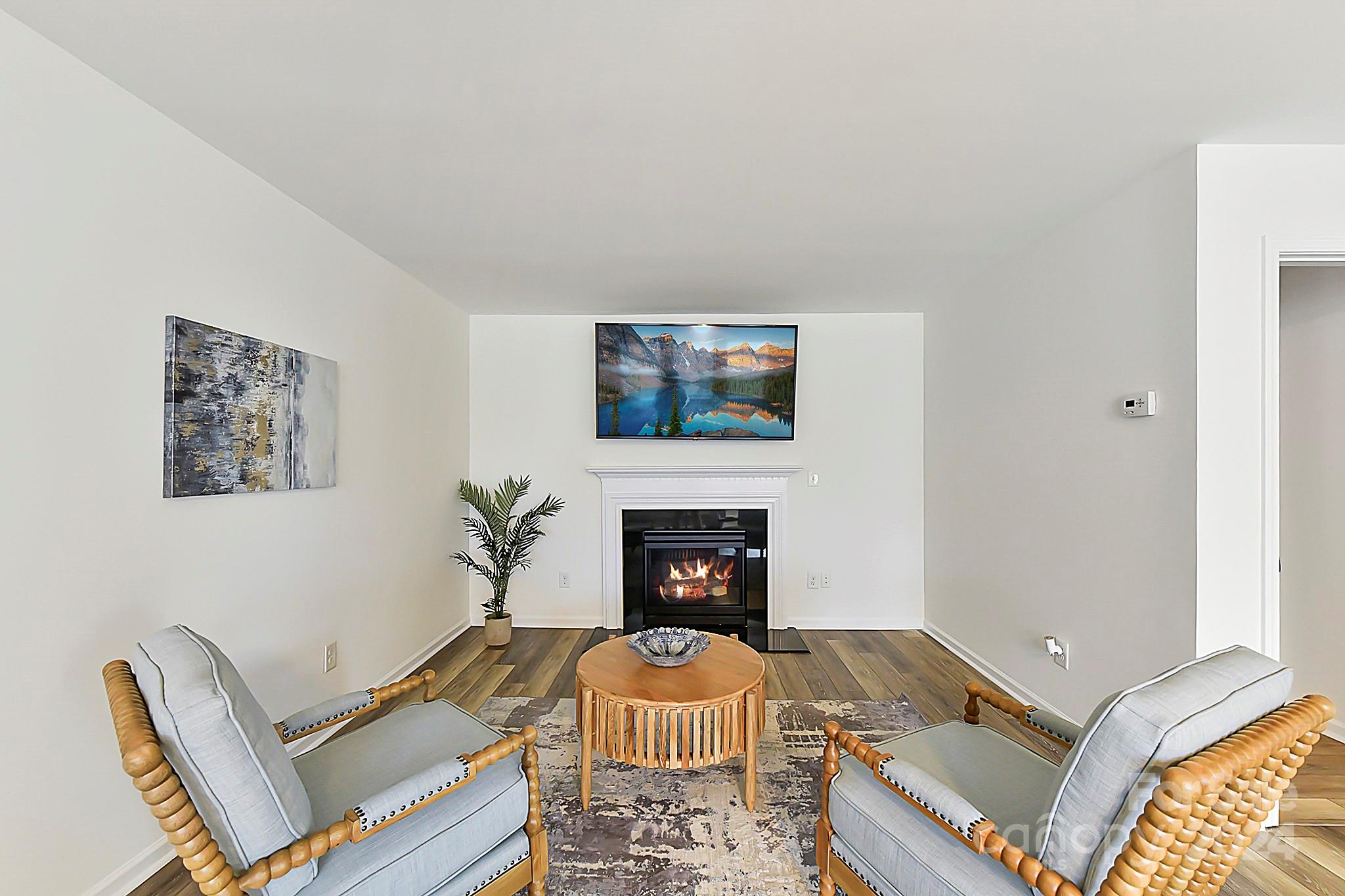 1201 Screech Owl Road Waxhaw, NC 28173 - Photo 25 of 43 a living room with furniture fireplace and a fireplace