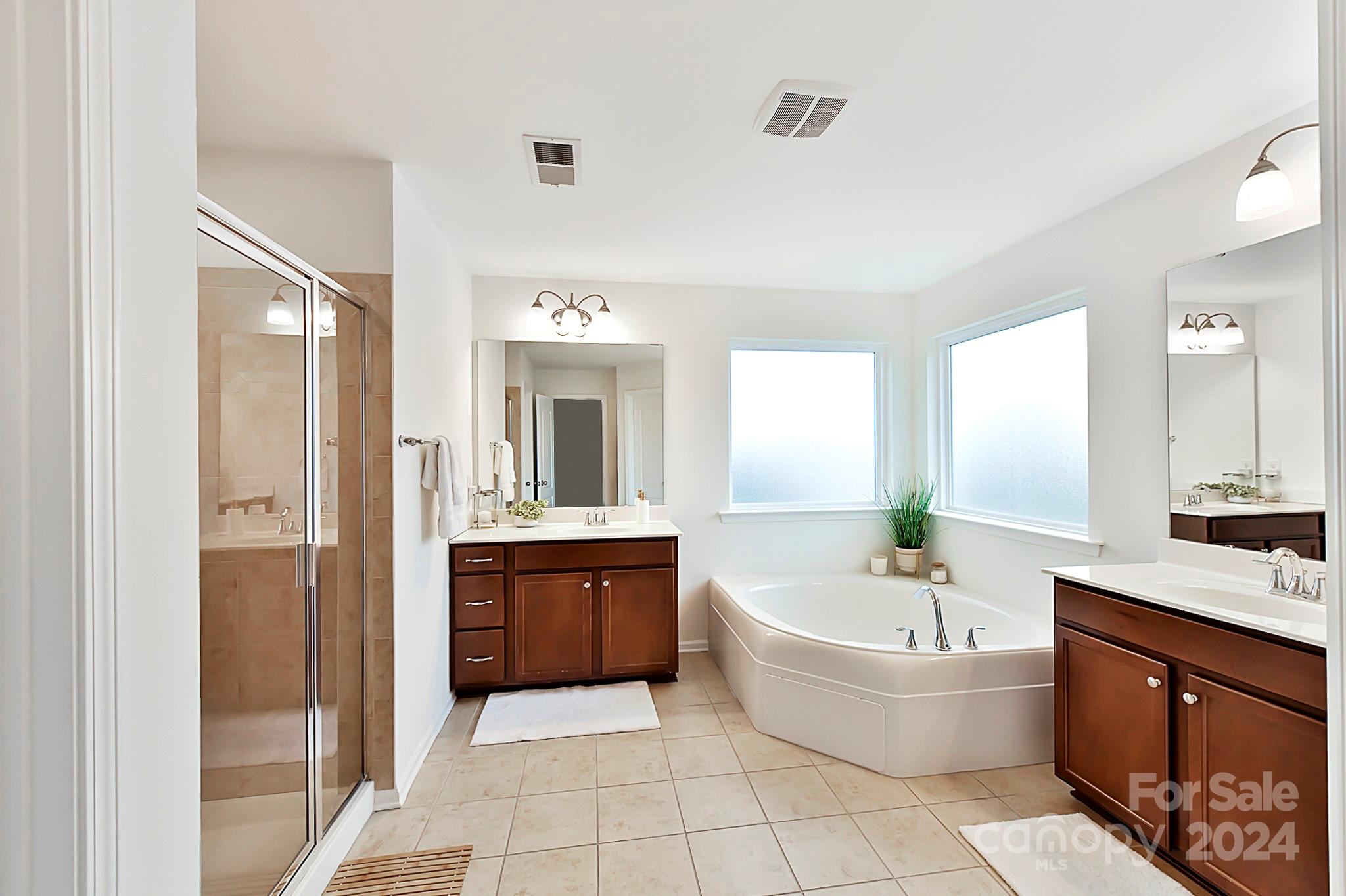 1201 Screech Owl Road Waxhaw, NC 28173 - Photo 26 of 43 a large spacious bathroom with a granite countertop tub sink and mirror